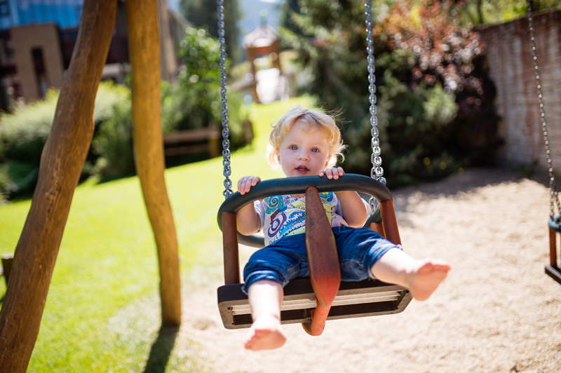 little-boy-on-the-swing-at-the-playground-PZ5DNSW.jpg
